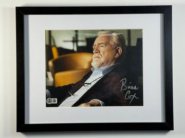 Framed photo of an older man with a signature.