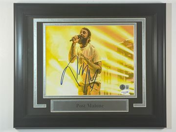 Autographed framed photo of Post Malone performing.