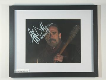 Framed signed photo of a man holding a barbed bat.