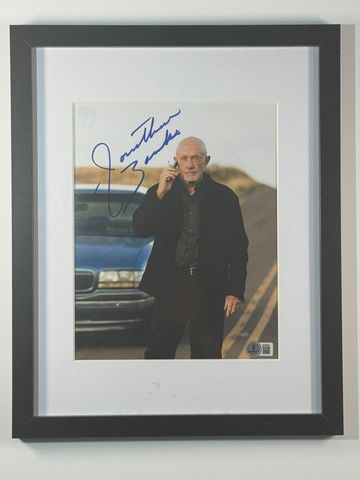 Framed signed photo of a man on a road.
