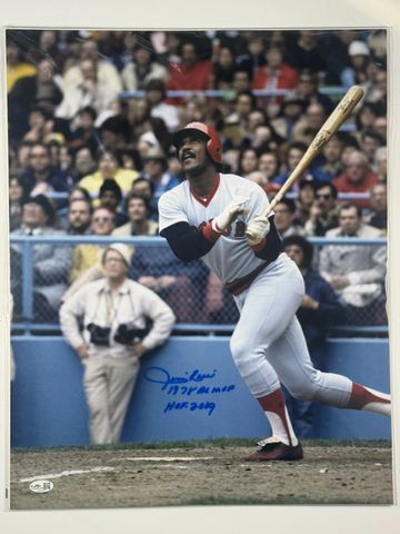 Baseball player in mid-swing during a game.