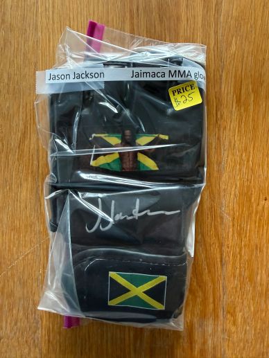 Packaged black MMA gloves with Jamaican flag and signature.