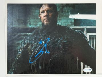 Signed photo of a man in dark, textured clothing.