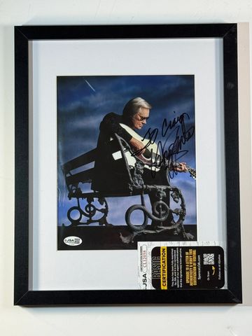 Framed signed photo of a man playing guitar.