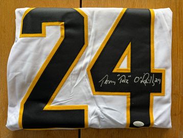 Folded signed jersey with number 24.