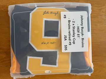 Signed Johnny Bucyk Bruins memorabilia in protective case.