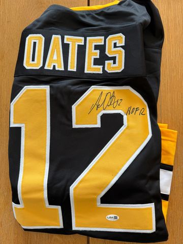 Autographed Oates #12 sports jersey with HOF 12 inscription.