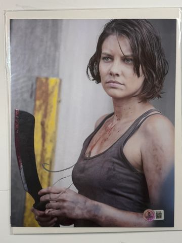 Woman holding a bloodied machete, looking intense.