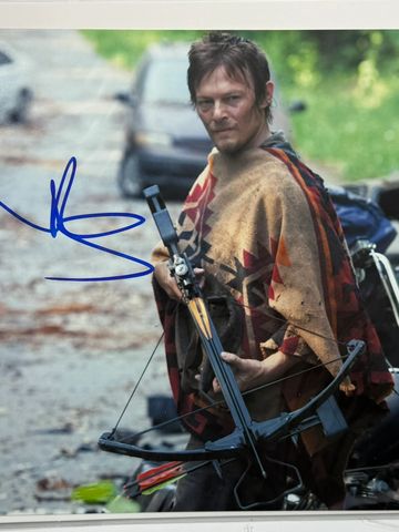 Man holding a crossbow outdoors.