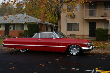 A cherry red car collecting toys for the Annual Toy Drive with Devotions Car Club of Sacramento 2010