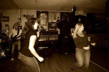 The ladies kick of their shoes to dance to Live entertainment in Cameron Park at a local bar.