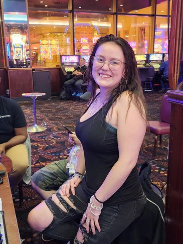 Smiling woman posing in a casino setting.