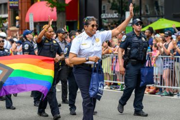 Police officers celebrating at a pride parade.