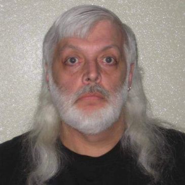 Older man with long white hair and beard.