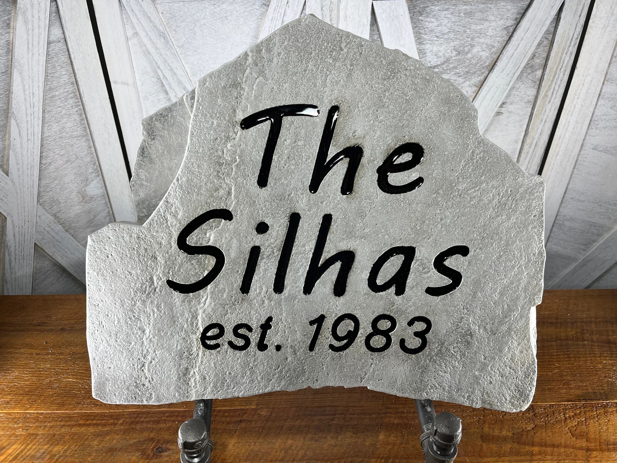 Stone plaque with "The Silhas est. 1983" inscribed.