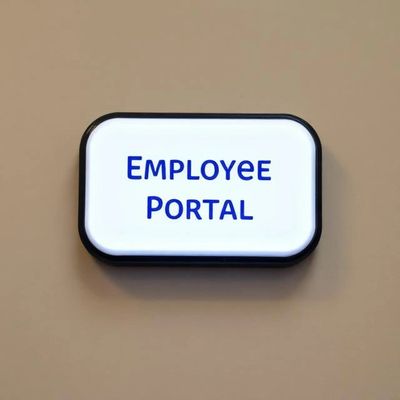 Illuminated sign reading 'EMPLOYEE PORTAL' on a beige wall.
