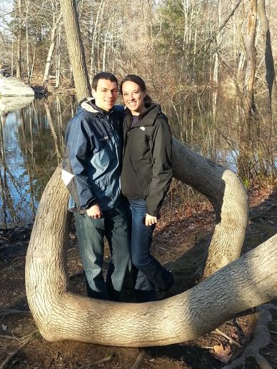 Daughter and husband standing in a tree trunk that grew into a 360 degree loop