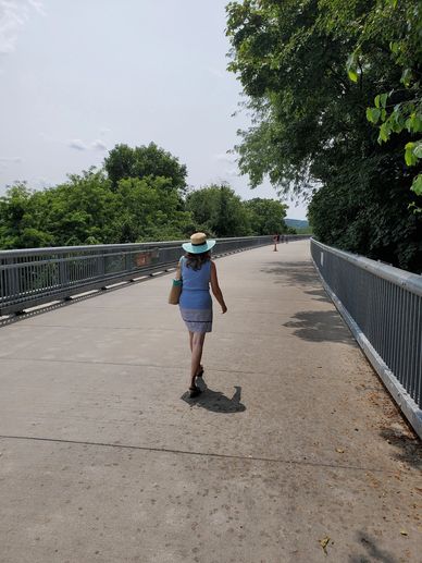 my wife walking across a scenic pedestiran bridge