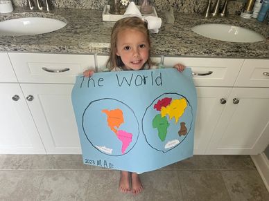 Granddaughter holding a big map of the world