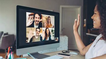 Woman video chatting with four friends on a computer.