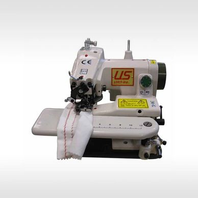 Industrial sewing machine stitching fabric with red thread.