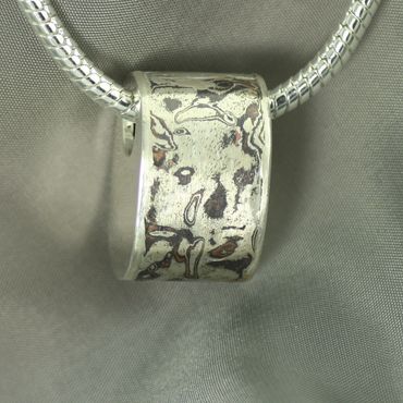 This sterling silver bead  pendant features Mokume Gane.Does not include chain.  