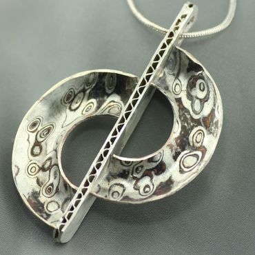 Sterling silver pendant features Mokume Gane.  Does not include chain.