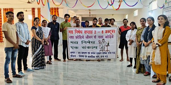 Group of people holding a banner for a drug prohibition week event in India.
