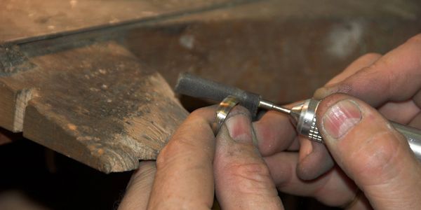a man creating jewelry.