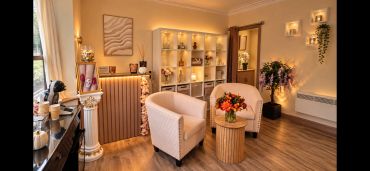 Cozy, well-lit room with elegant chairs and floral decor.