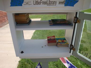 Loami Little Library box with books in it.
