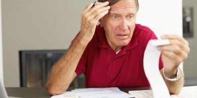 Man holding a list, looking confused, showing signs of forgetfulness.