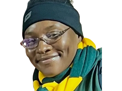 Person smiling warmly with glasses and a headband outdoors at night.