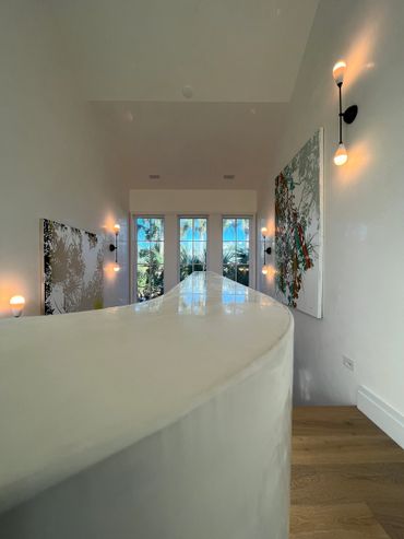 Modern interior with abstract art and natural light from large windows.