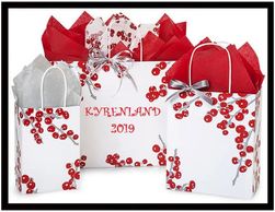 Set of red and white gift bags with cherry designs and colorful tissue paper.
