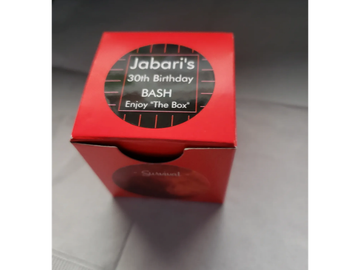 Red box with a sticker for Jabari's 30th birthday bash.