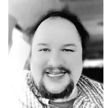 Smiling man in a car interior, black and white photo.