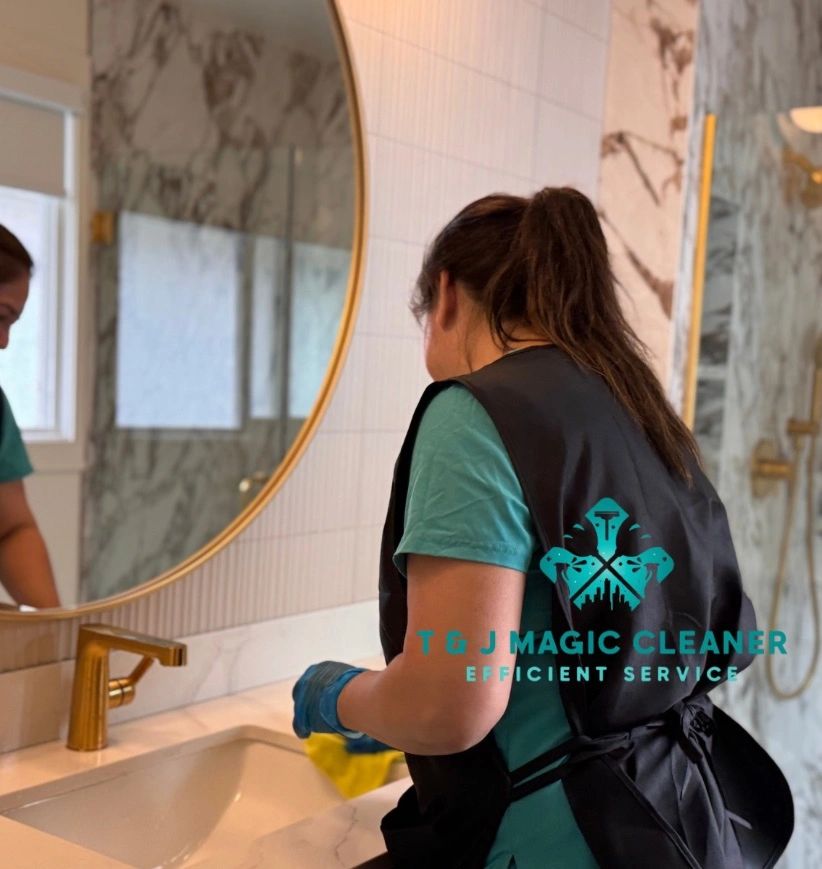 Cleaner wiping bathroom sink with yellow cloth.