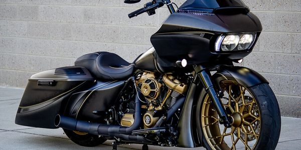 Custom black and gold motorcycle with a sleek design.