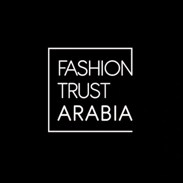 Fashion Trust Arabia logo on black background.