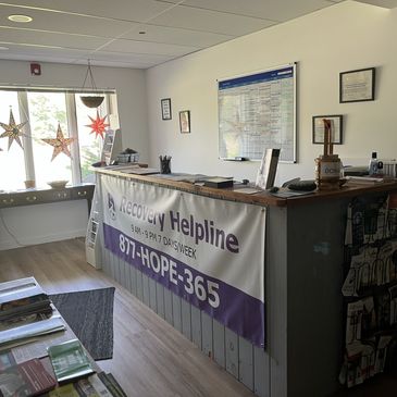 Reception area with recovery helpline banner and hanging star decorations.
