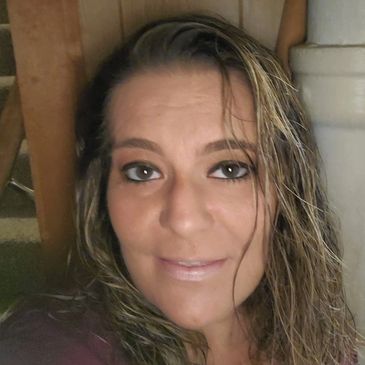 Close-up of a woman with wet hair and makeup.
