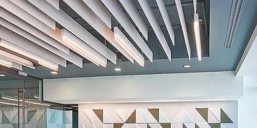 Hanging baffles and wall panels help control the reverb & noise in a restaurant