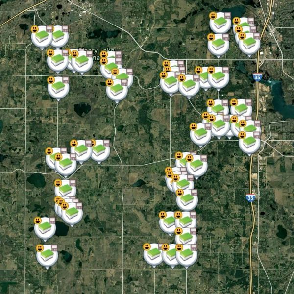 Map showing multiple location markers with smiley faces spread across a rural area.