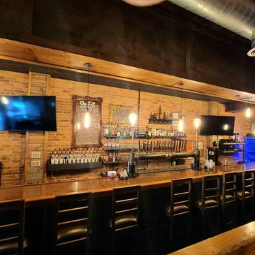 Wicked Warren's bar in Warren, PA with brick walls, old fashion lighting and liquor and draft beer.