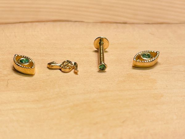 Fine 14K Yellow Gold Flat Back Hollow Screw Ear Piercings with green tsavorite, and threaded labret.