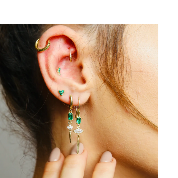 Curated ear, constellation piercing with gold and gemstones.
Helix, Conch, Daith, Lobes.