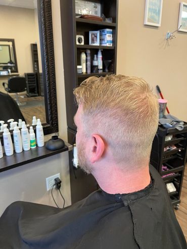 Man getting a fresh haircut in a salon.