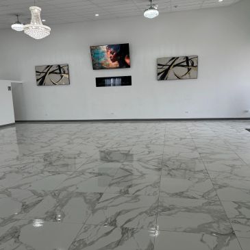 Modern room with marble floor, wall art, and screen display.