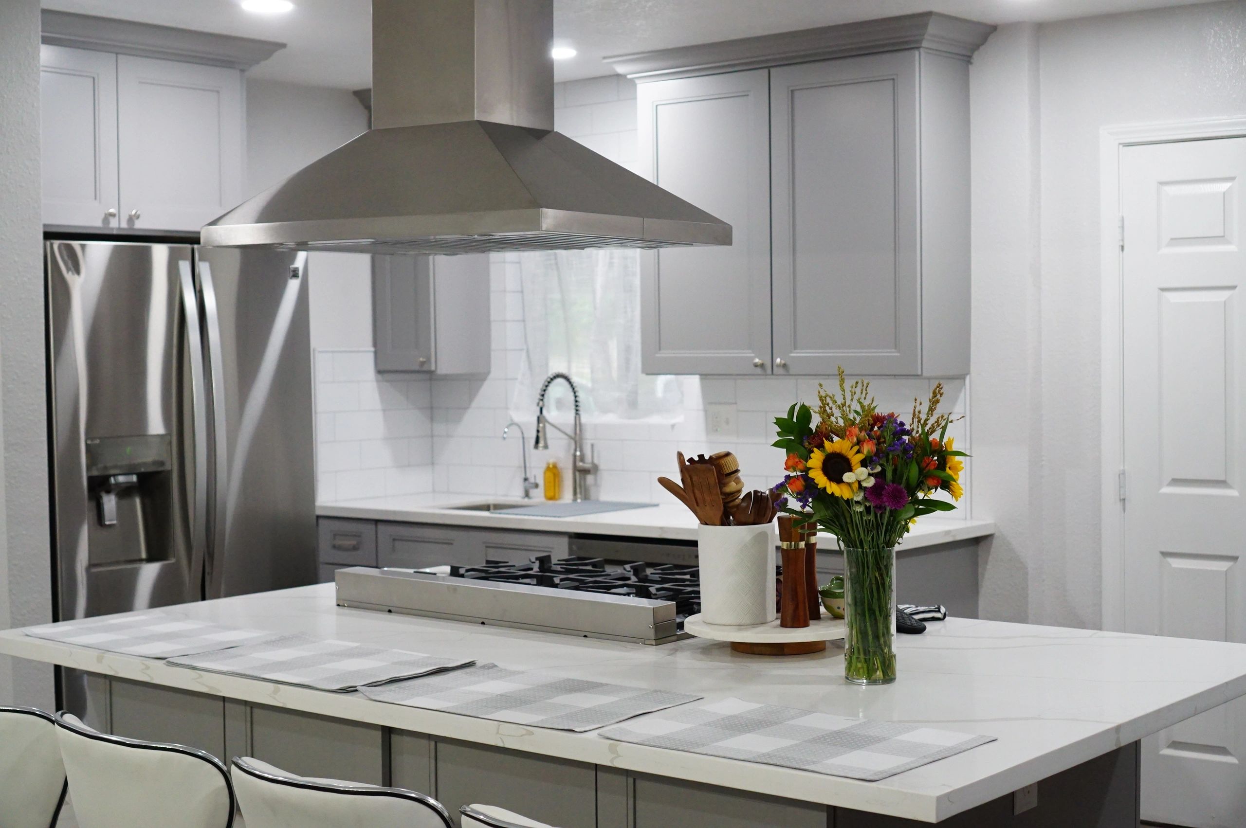 grey kitchen with quartz countertop and stainless steel appliances